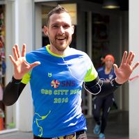 SNS City Run participant wearing custom running shirt during urban race event