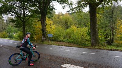 The perfect wind jacket for cycling at TD Sportswear displayed on a person standing next to a road.