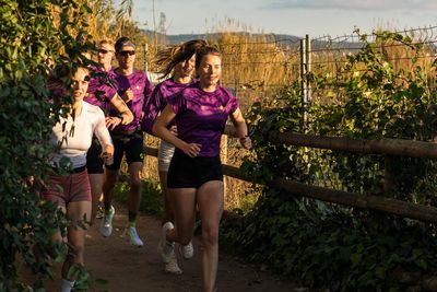 Custom running jersey with team logo and purple design from the PTC team – TD Sportswear