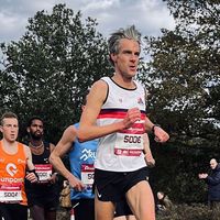 Runner wearing custom running singlet competing during race event with other athletes