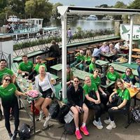 Adyen team wearing custom sports shirts in green during outdoor team event by the water