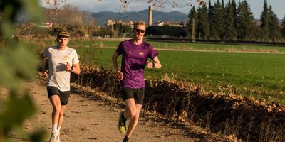 Custom printed running shirts with purple and white design with customer logo for events and team sports