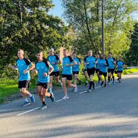 Rik Zorgt running team wearing custom running shirts training together on road outdoors
